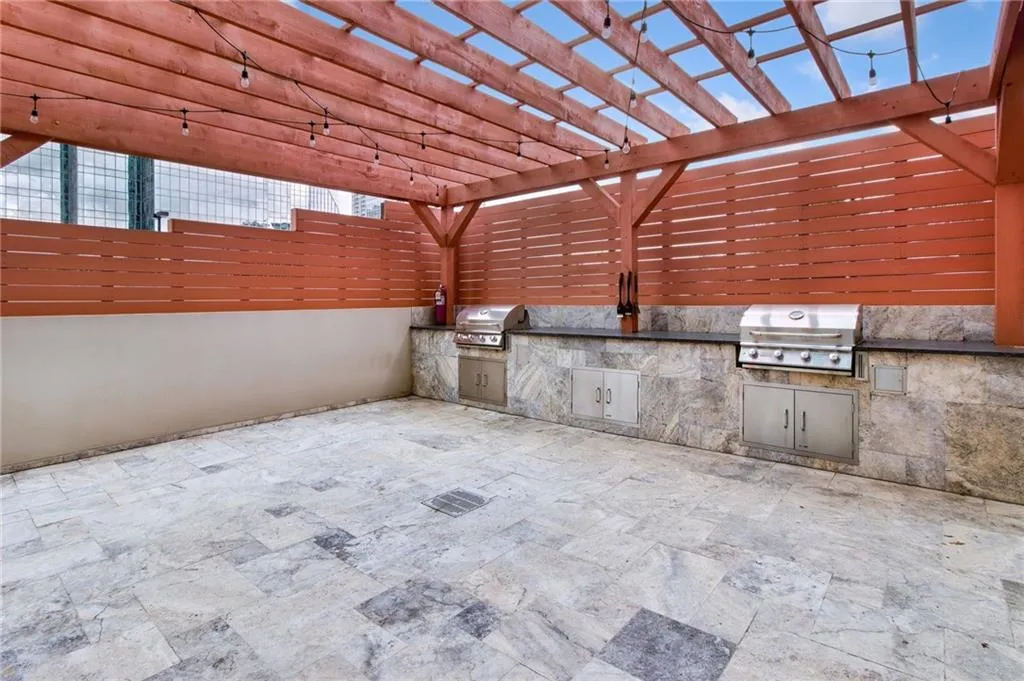 View of patio / terrace with an outdoor kitchen and a pergola