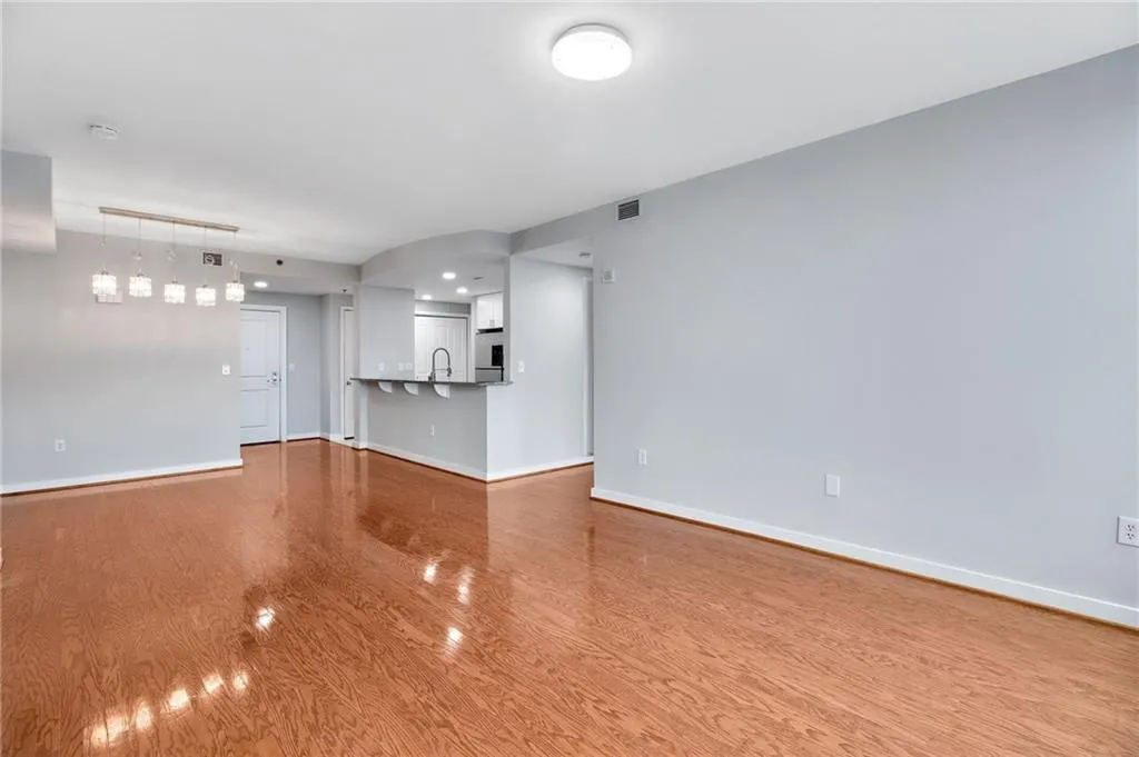 Unfurnished living room with wood finished floors and baseboards