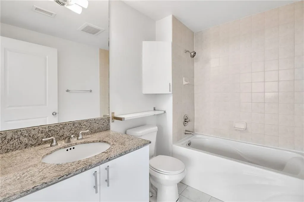 Bathroom featuring vanity, shower / washtub combination, and tile patterned floors
