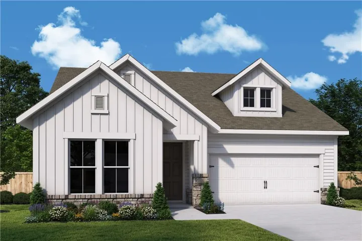 Gable roofline with dormer window, stone veneer accent, attached garage, manicured landscaping, and board and batten siding