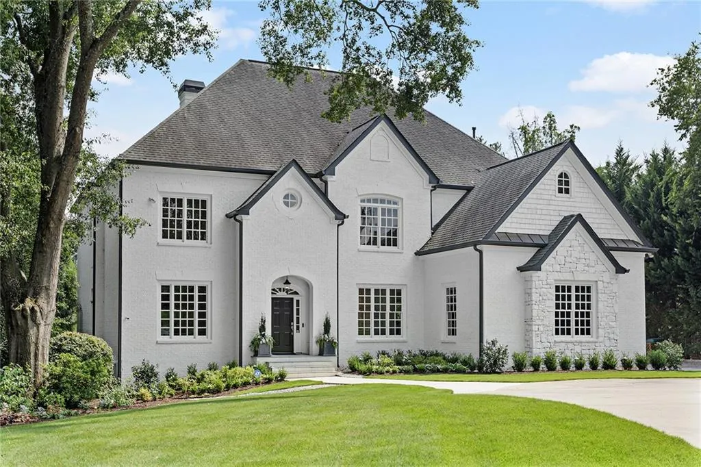 French country home with a front lawn