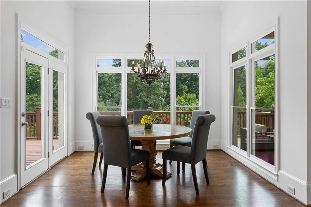 Dining room featuring plenty of natural light, a notable chandelier, and dark hardwood / wood-style flooring