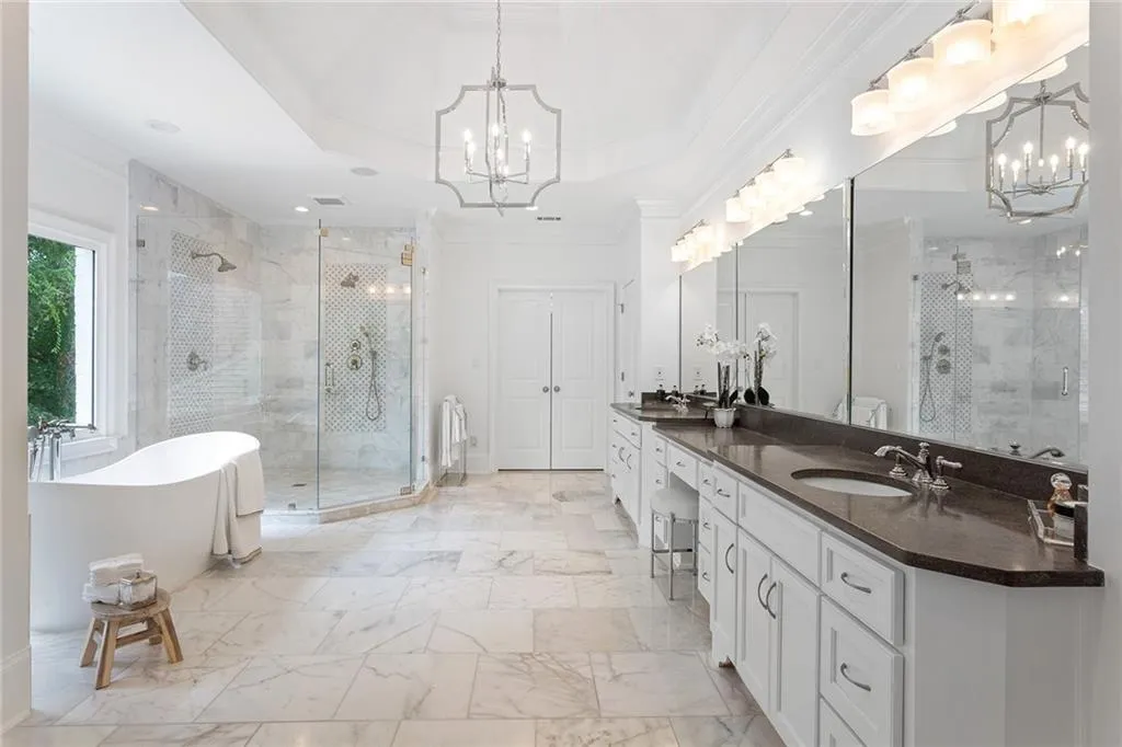 Bathroom with tile flooring, separate shower and tub, ornamental molding, and a chandelier