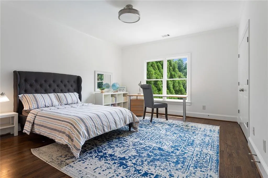 Bedroom featuring crown molding and dark hardwood / wood-style floors