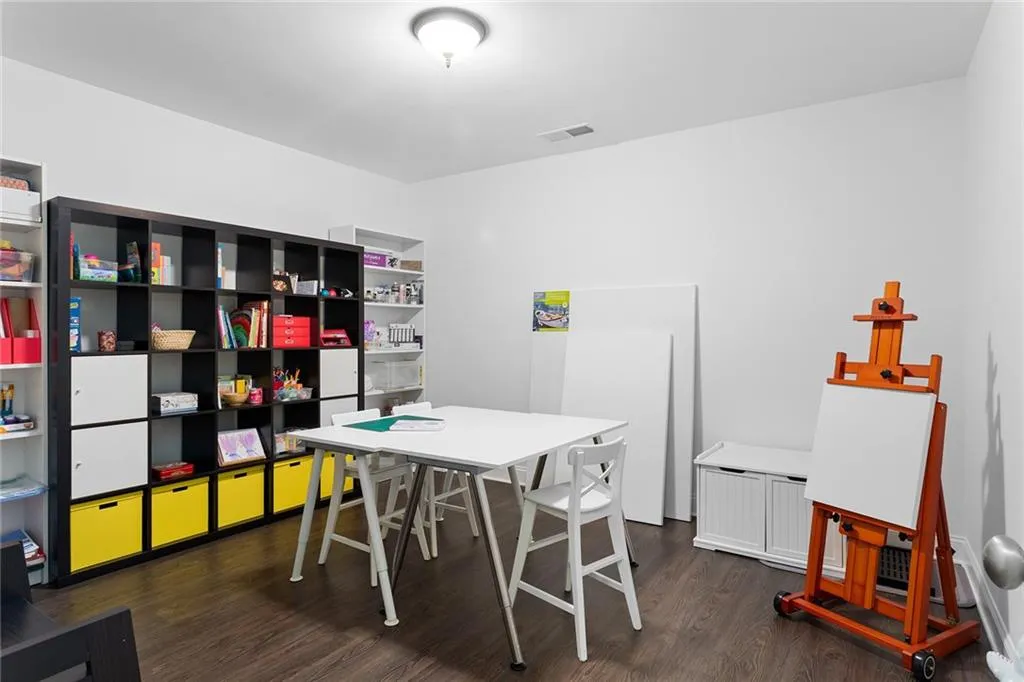 Office space with dark hardwood / wood-style floors