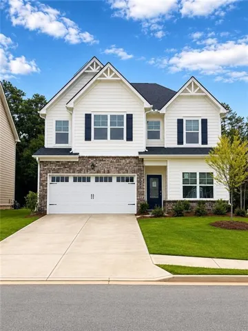 Two-story residence featuring white siding and dark shutters