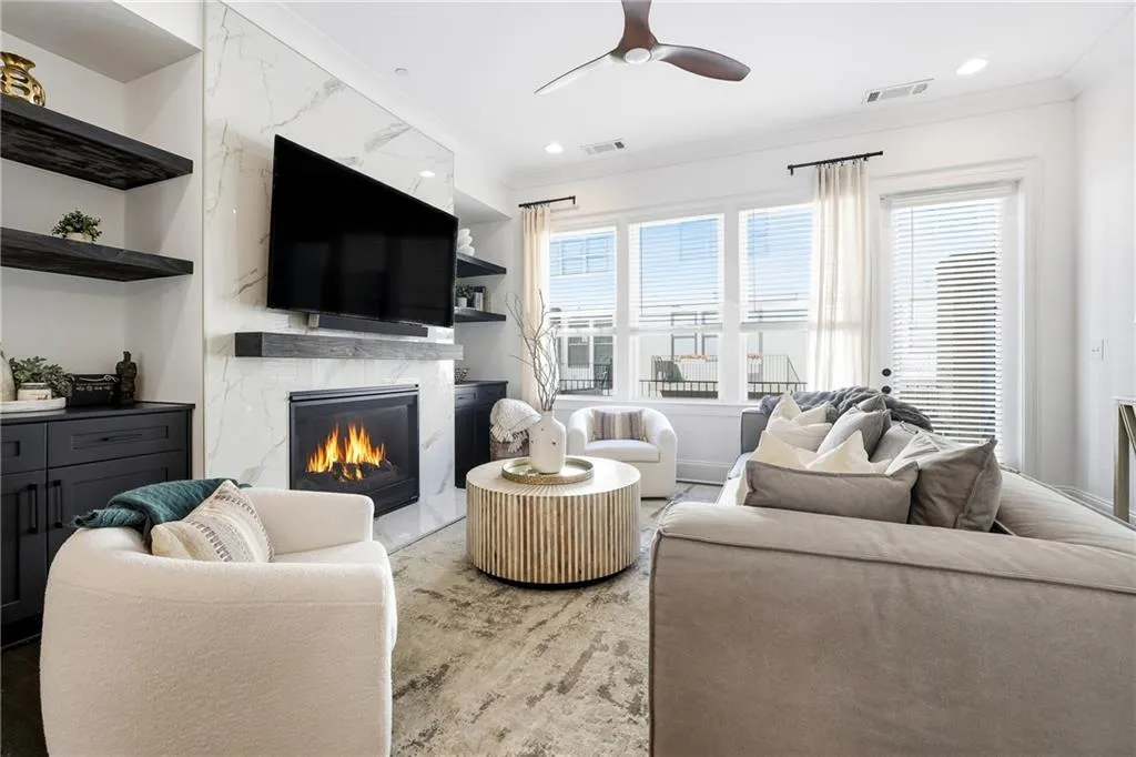 Beautiful Family Room with added Custom Built Cabinetry, Shelves and a fully Redesigned Fireplace wall complete with Marble and Mantle.