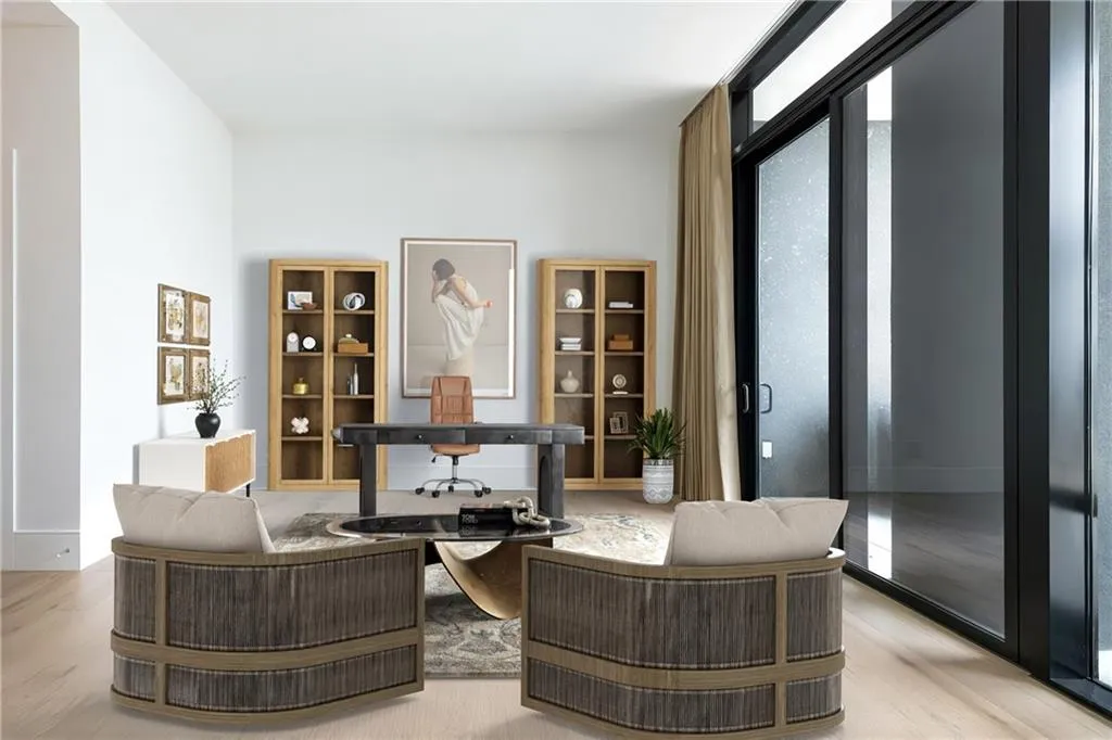 Office/den with adjacent half bath and access to the outdoor patio