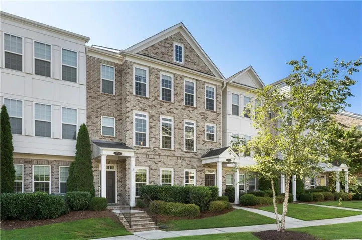 Front of 3 story brick townhome-with walk up entrance