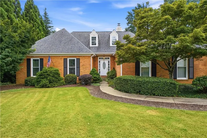 Brick exterior featuring a gabled roofline and dormer windows