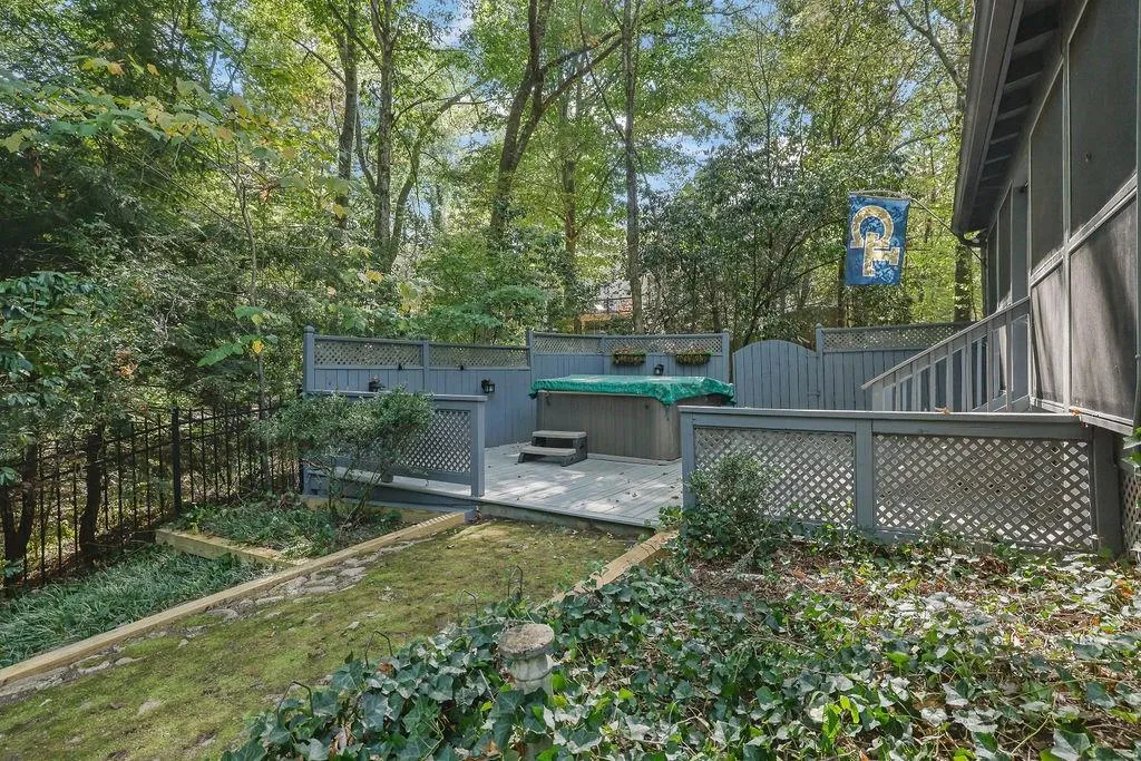 View of yard with a hot tub and a wooden deck