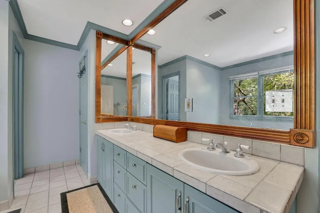 Bathroom featuring vanity, crown molding, and tile patterned floors