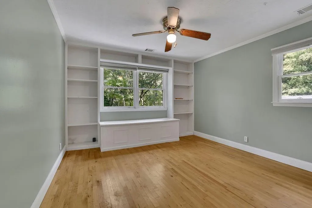 Unfurnished room with light hardwood / wood-style flooring, ceiling fan, and crown molding