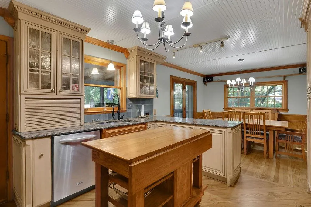 Kitchen featuring dishwasher, decorative light fixtures, plenty of natural light, and a notable chandelier