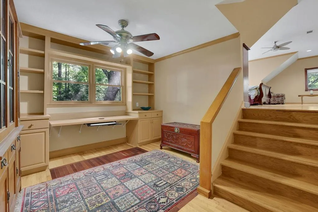 Office featuring ornamental molding, ceiling fan, and light hardwood / wood-style flooring