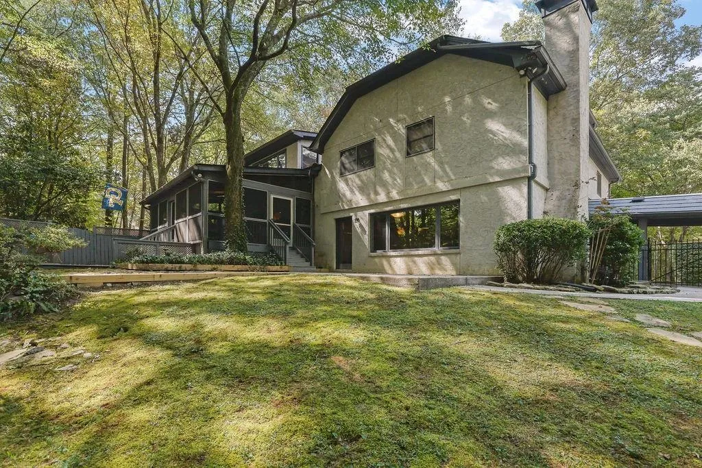Back of house with a lawn