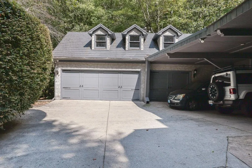 Garage featuring a carport