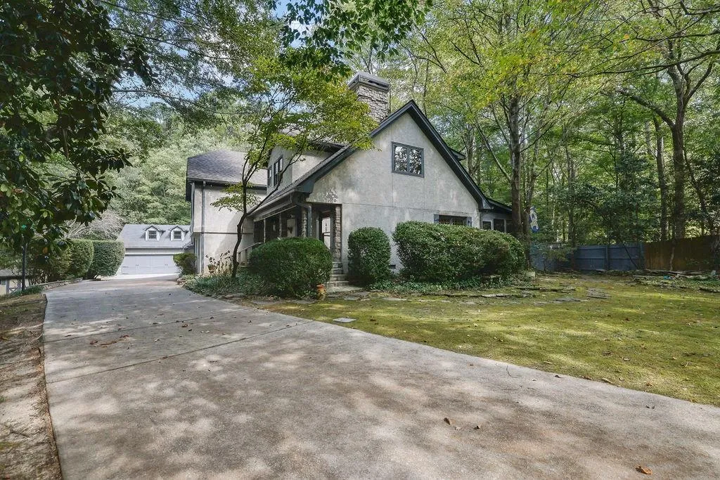 View of front of home with a front lawn and a garage