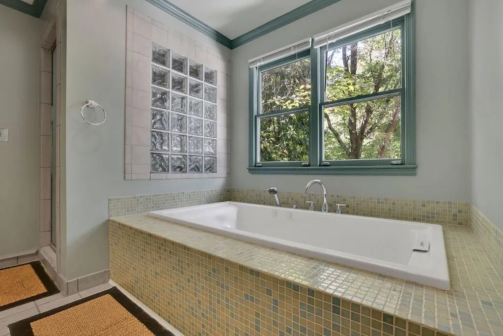 Bathroom featuring ornamental molding, tile patterned floors, and separate shower and tub