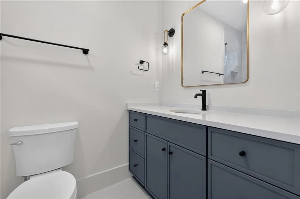 White countertop with an integrated sink and matte black faucet