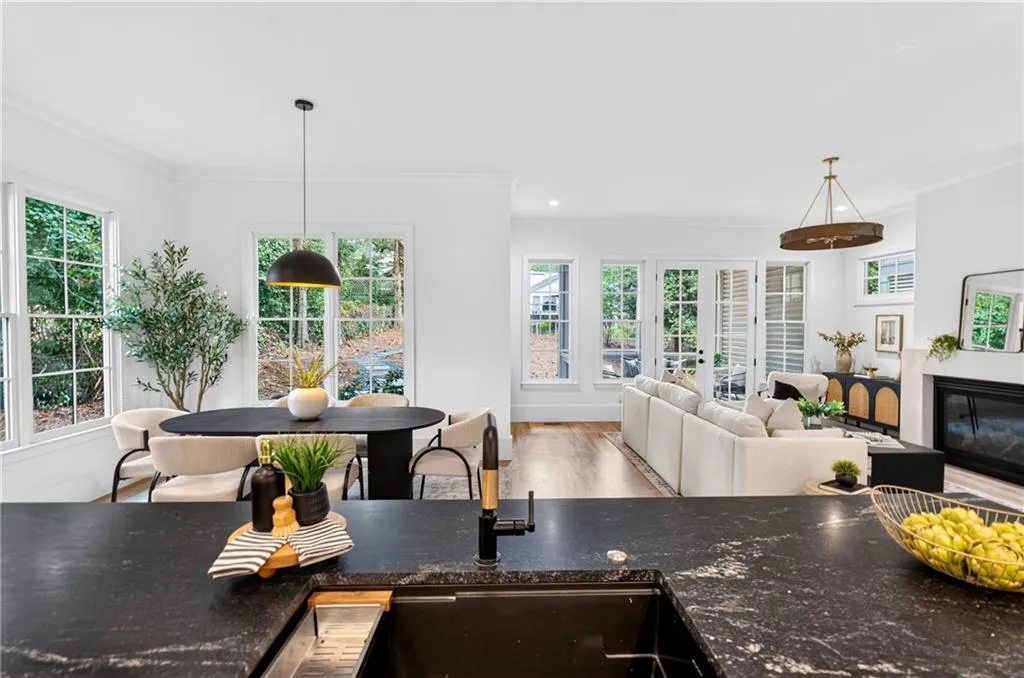 Kitchen island with dark stone countertop and integrated sink