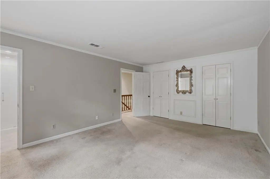 Primary bedroom features his and hers closets