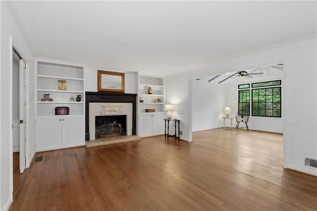 Bookcases flank the brick surround fireplace