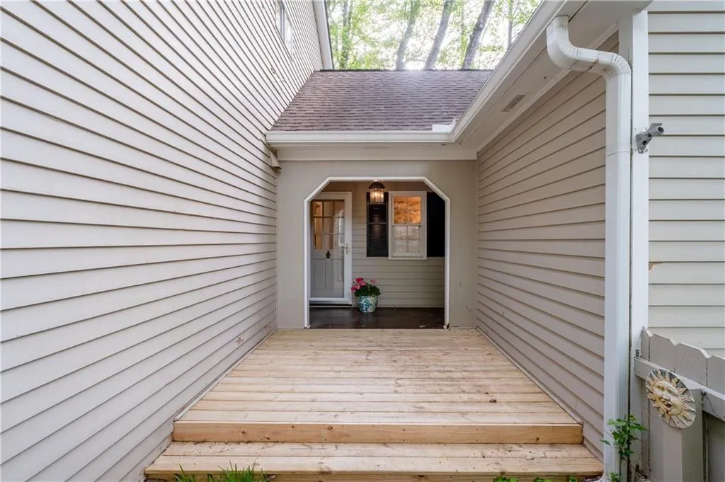 Breezeway entrance to rear hallway with powder room, laundry area, rear stairs, doors to deck and garage!