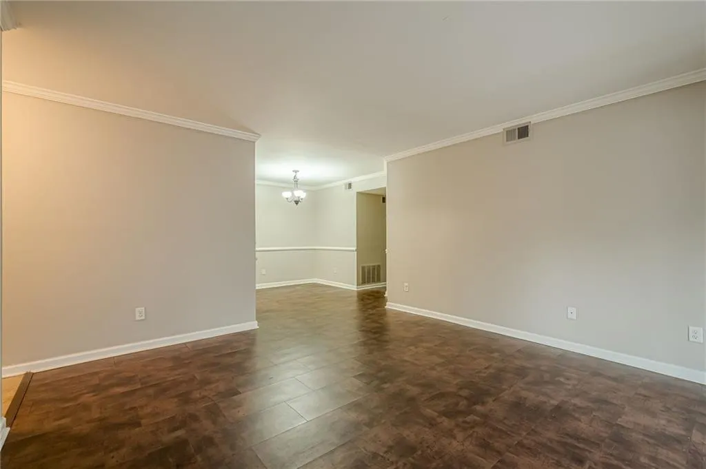 Spare room with a chandelier and ornamental molding