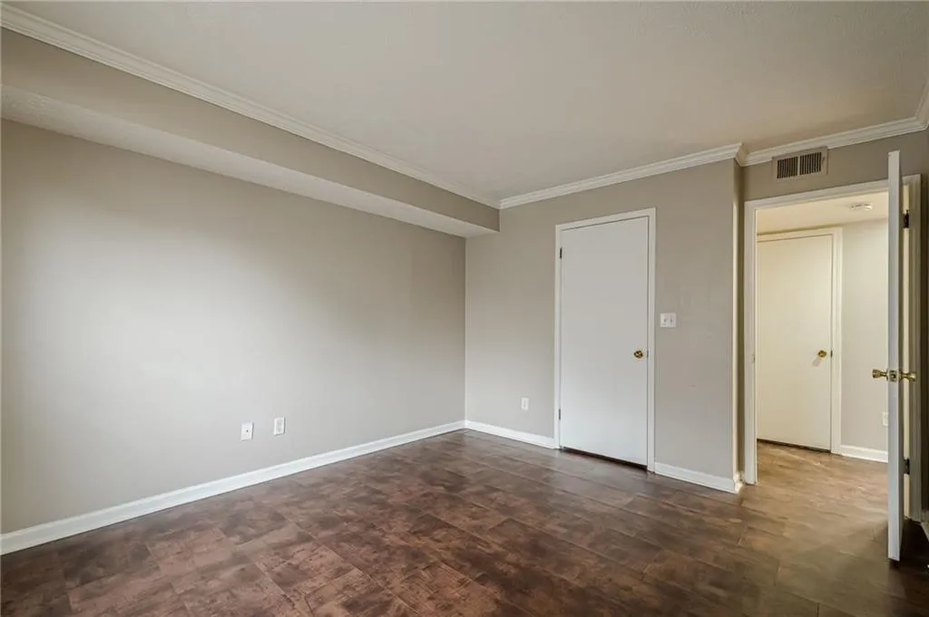 Unfurnished bedroom featuring baseboards and ornamental molding