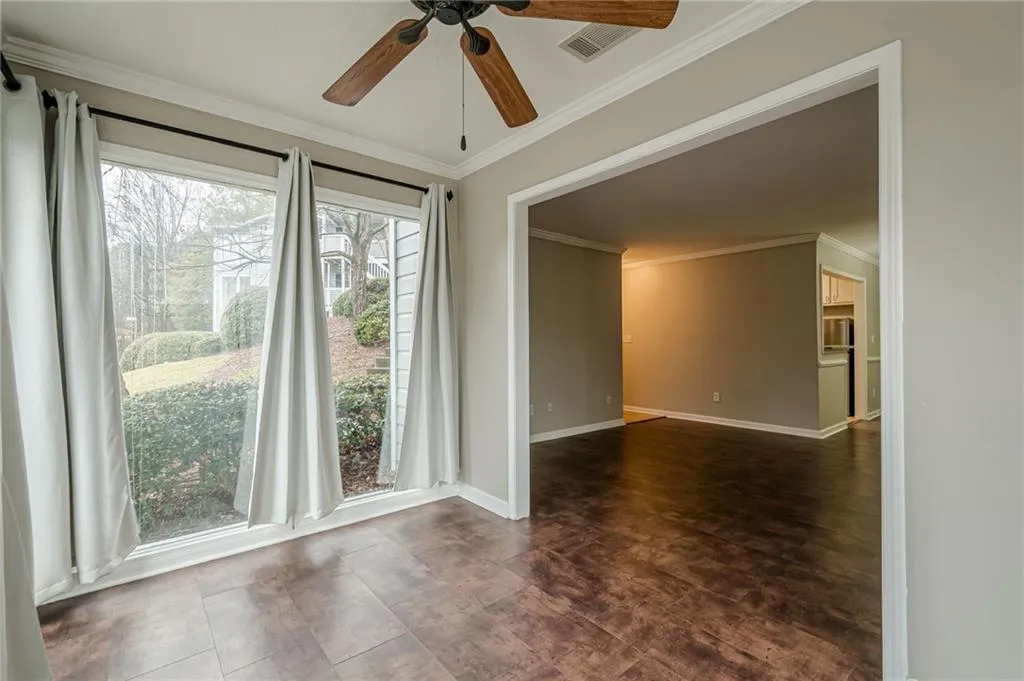 Spare room featuring ornamental molding and ceiling fan