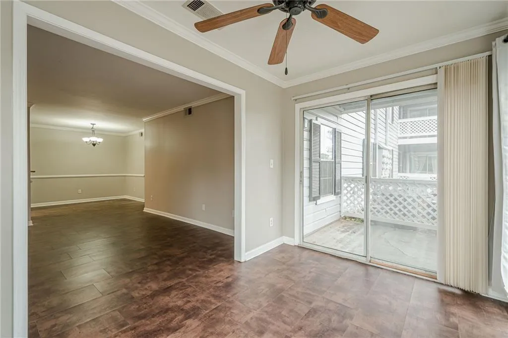 Unfurnished room with ornamental molding, a ceiling fan, and a chandelier