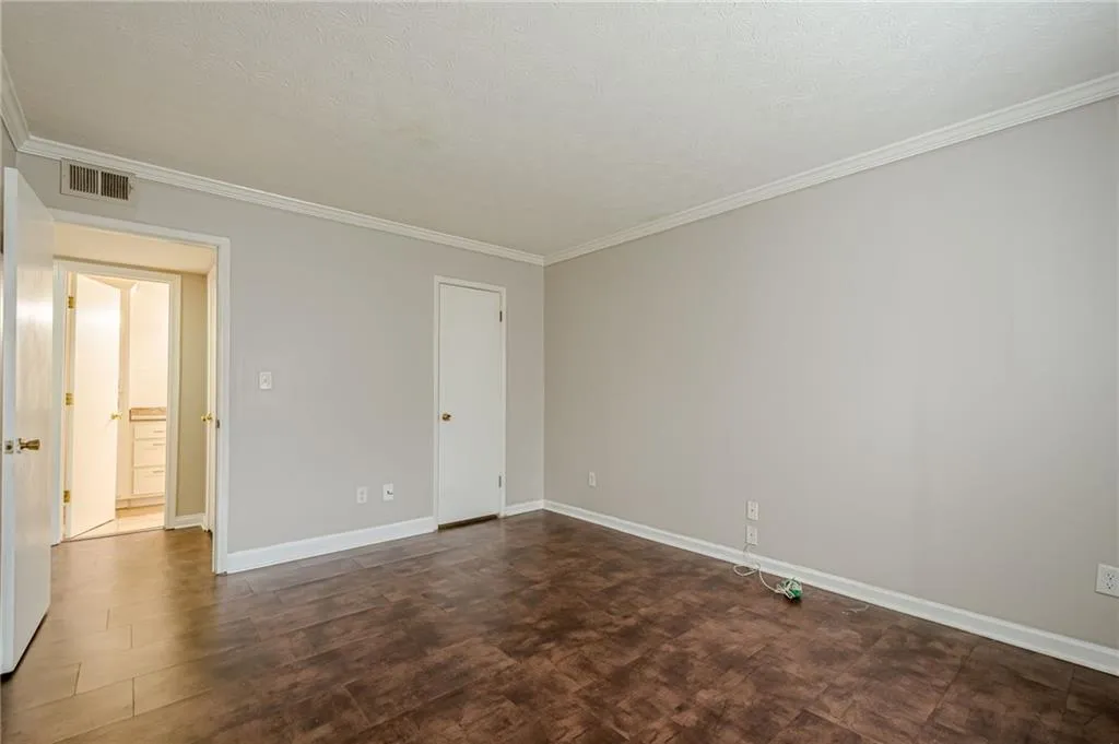 Unfurnished room featuring ornamental molding and a textured ceiling