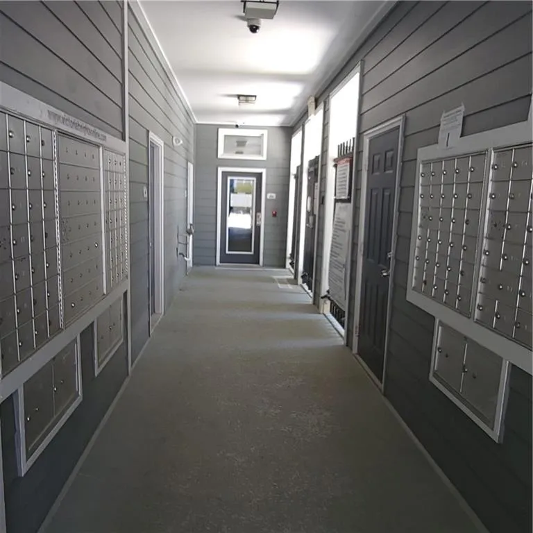 Hallway with mail boxes and wood walls