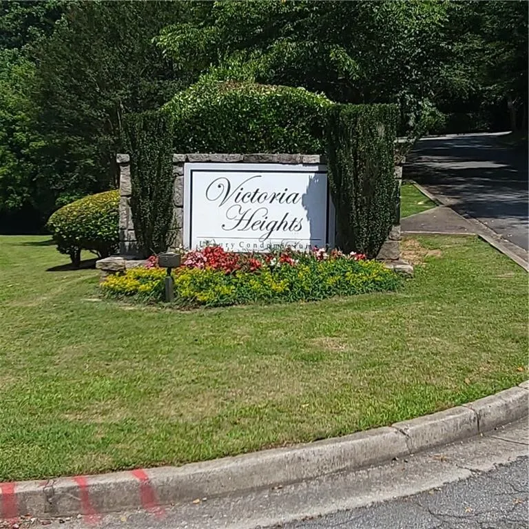 Community / neighborhood sign featuring a yard