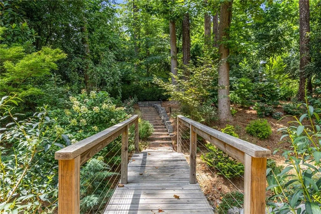 This foot bridge leads to the park-like backyard