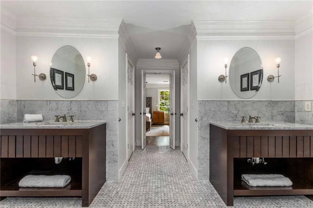Two handsome contemporary furniture vanities feature marble tops