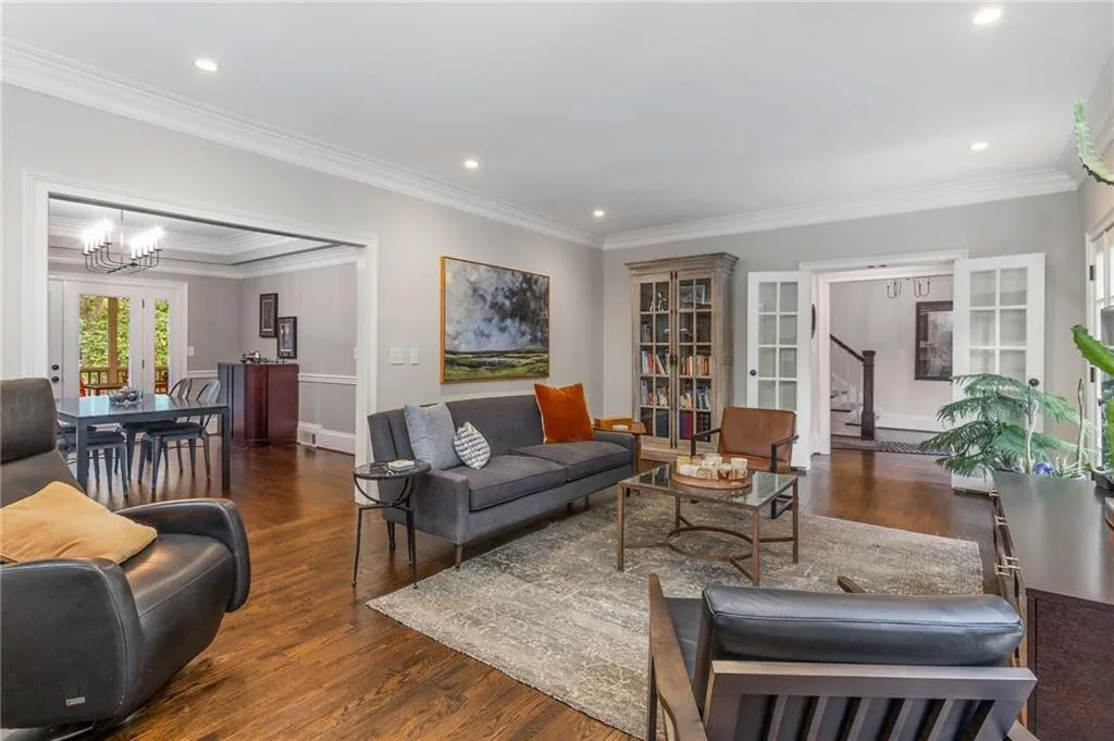 The living room features hardwood floors, French doors, recessed lights and 9' ceilings