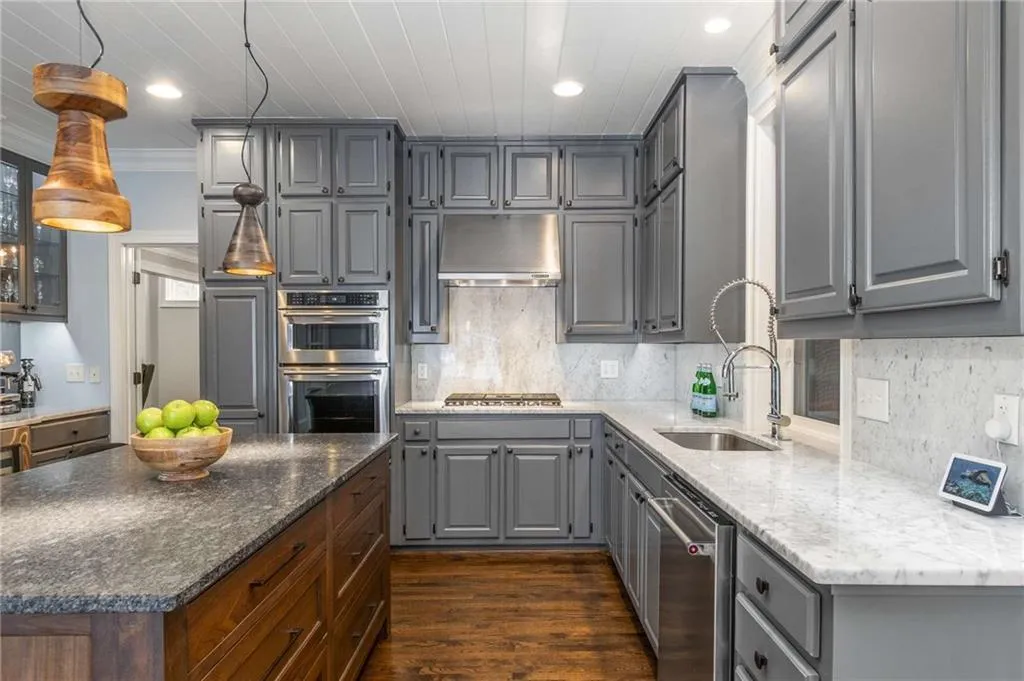 The marble countertops are punctuated by marble slab backsplash