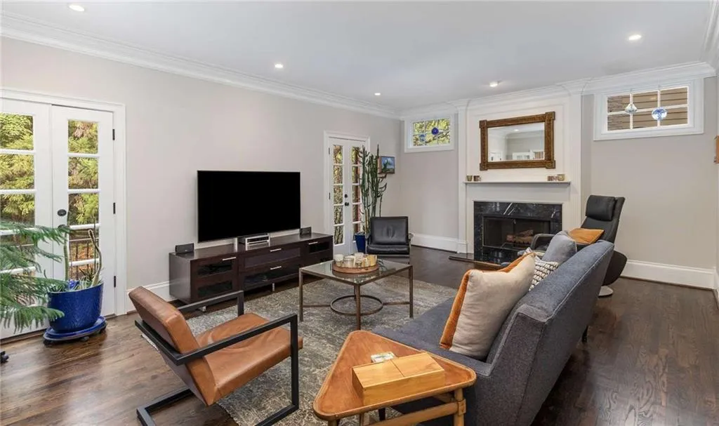 The living room features a fireplace and transom windows which allow for furniture placement