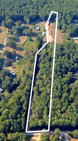 Aerial overview of property's location featuring a heavily wooded area and property boundaries highlighted