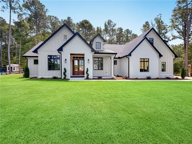 White brick and vertical siding exterior with dark trim