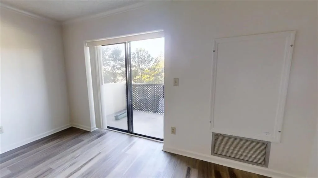 Unfurnished room with light wood-type flooring and crown molding