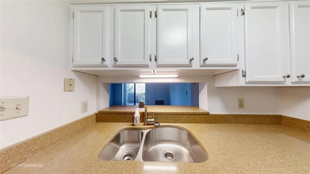 Kitchen view of white cabinetry