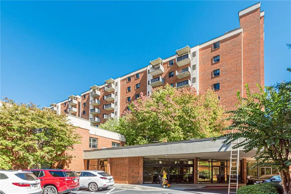 View of apartment building / complex featuring a parking lot