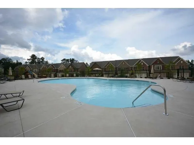 Community pool featuring a patio area and a residential view