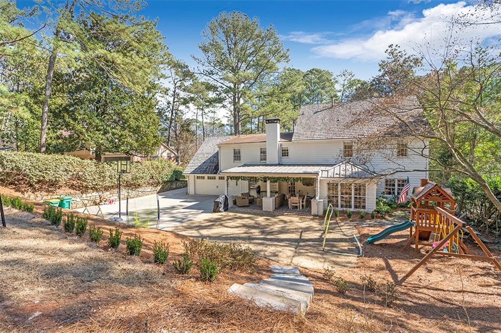 Back of house featuring a patio area and a playground