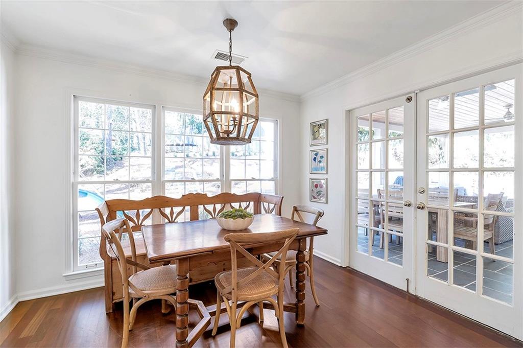 Dining room featuring a chandelier, plenty of natural light, dark hardwood / wood-style flooring, and crown molding