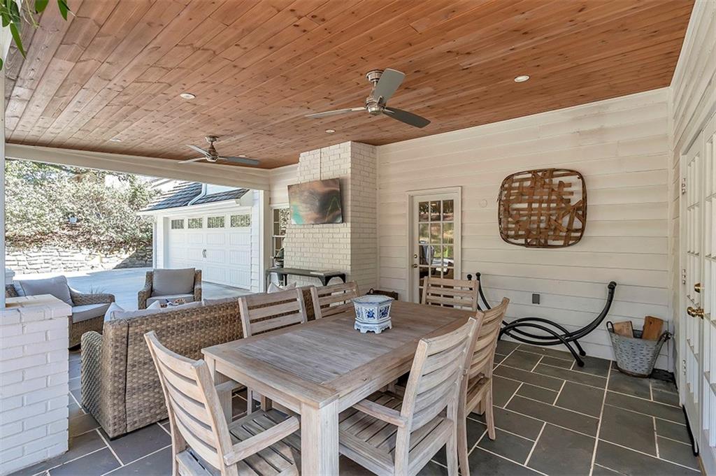 View of terrace featuring a fireplace and ceiling fan