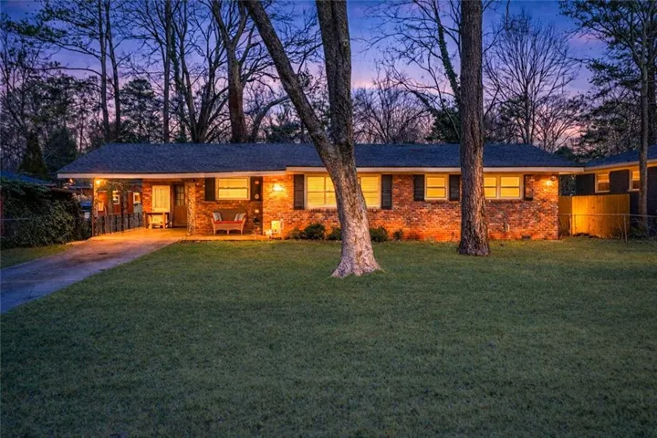 Ranch-style home featuring covered porch and driveway